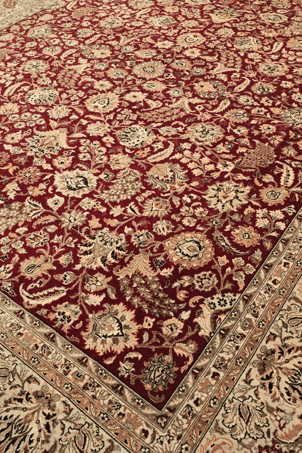 Shah Abbasi floral detail in burgundy and camel on Pakistani rug