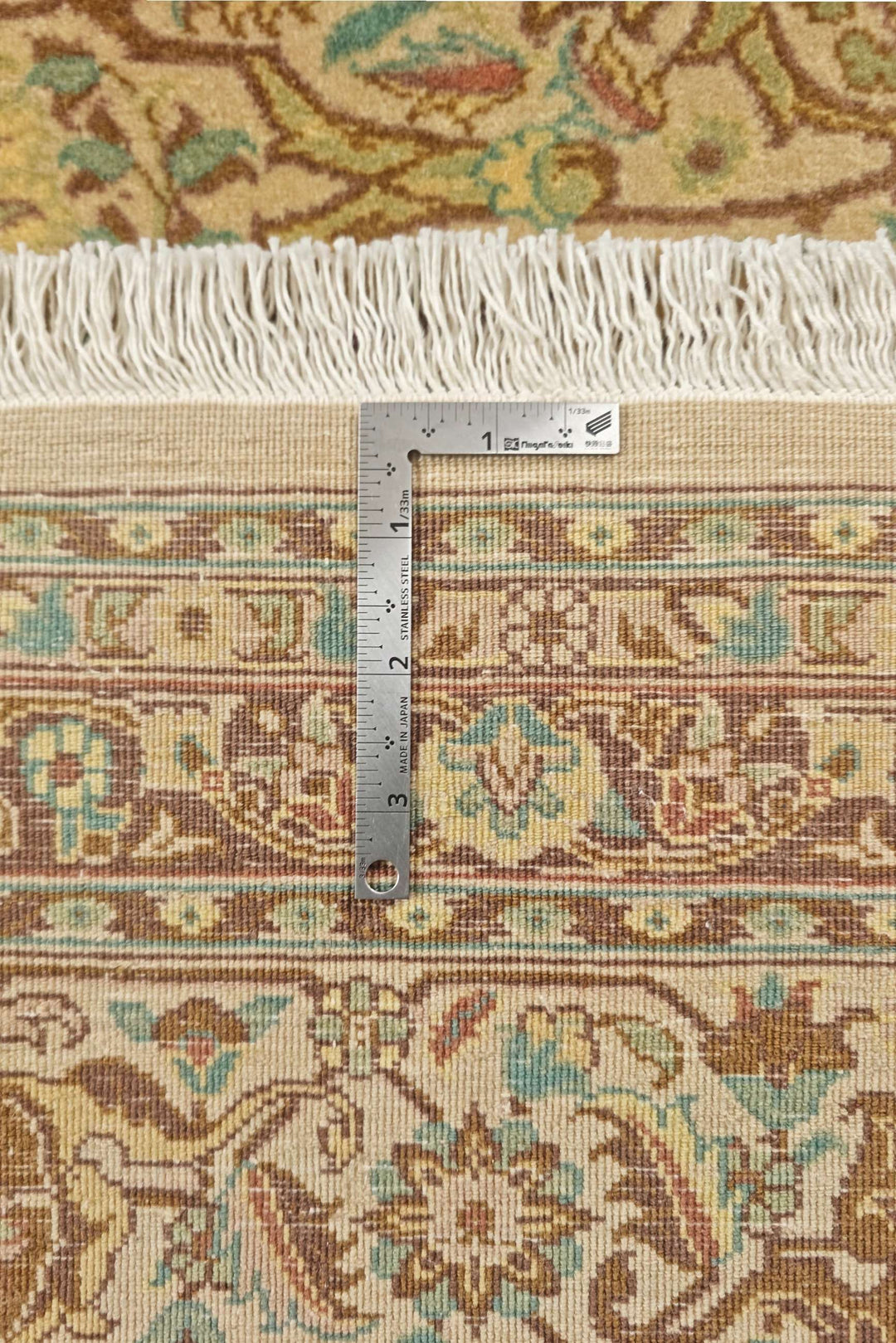 Corner of cream brown lattice Pakistani double-knot rug