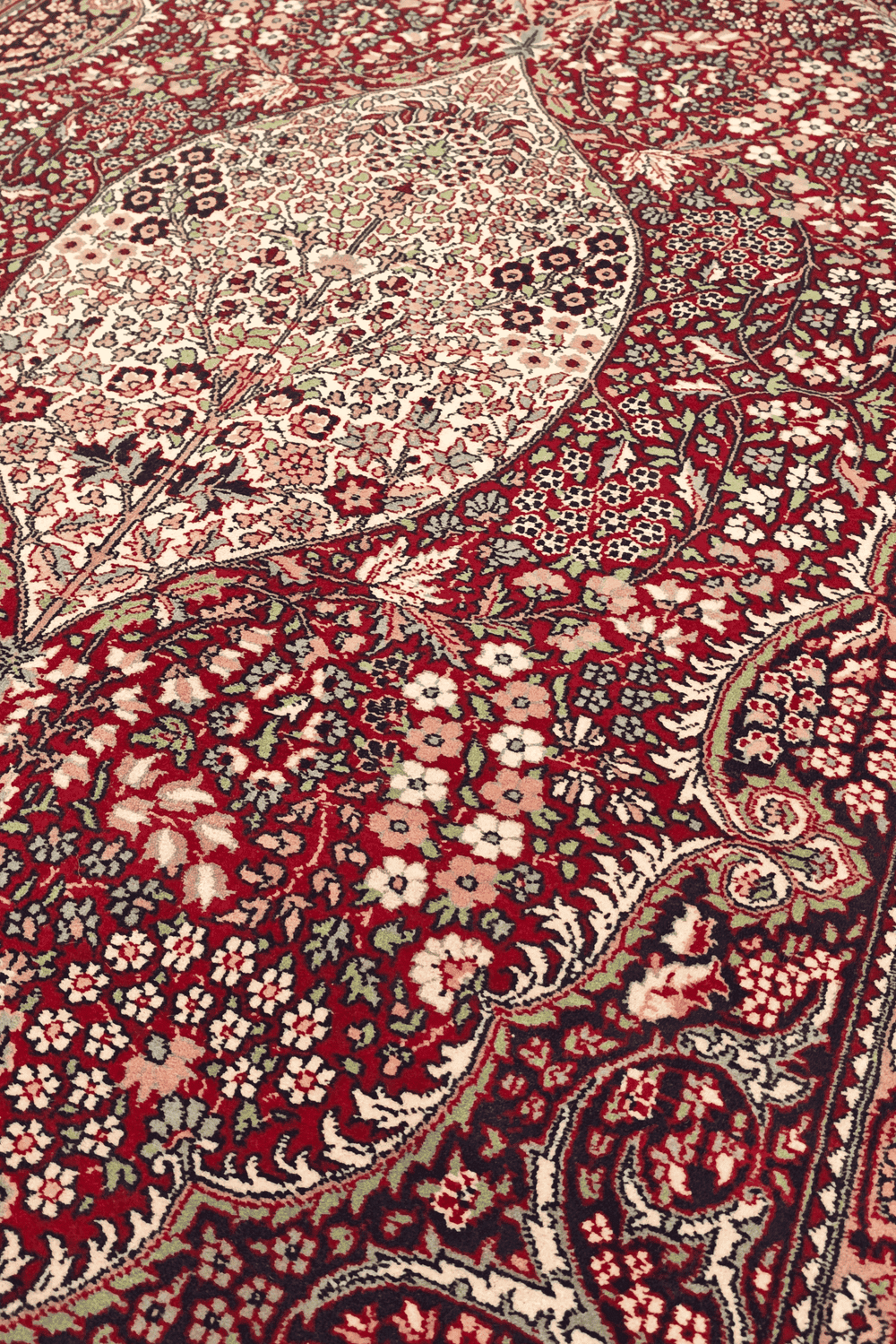 Medallion detail in deep ruby red on Tabriz rug