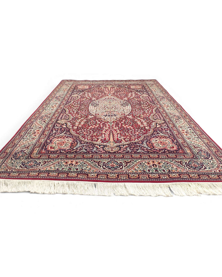 Fringe of ruby red Tabriz hand-knotted rug