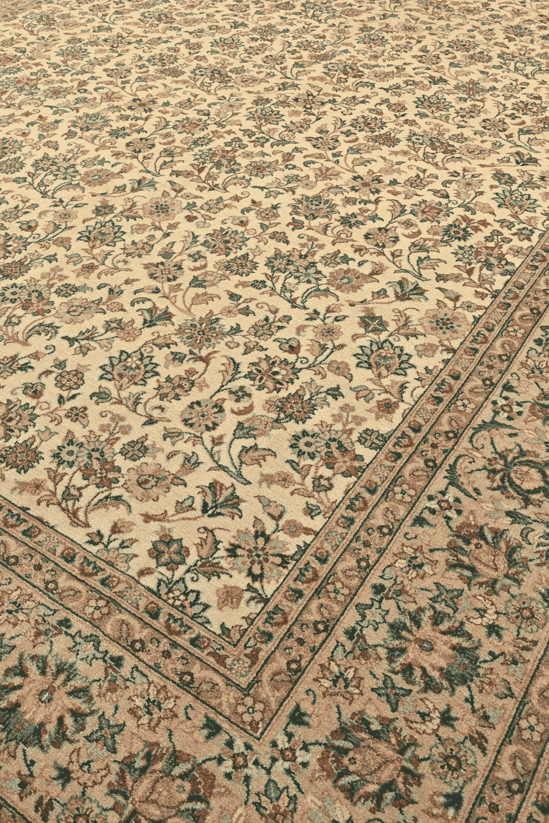 Afshan floral vine detail in cream and green on Pakistani rug