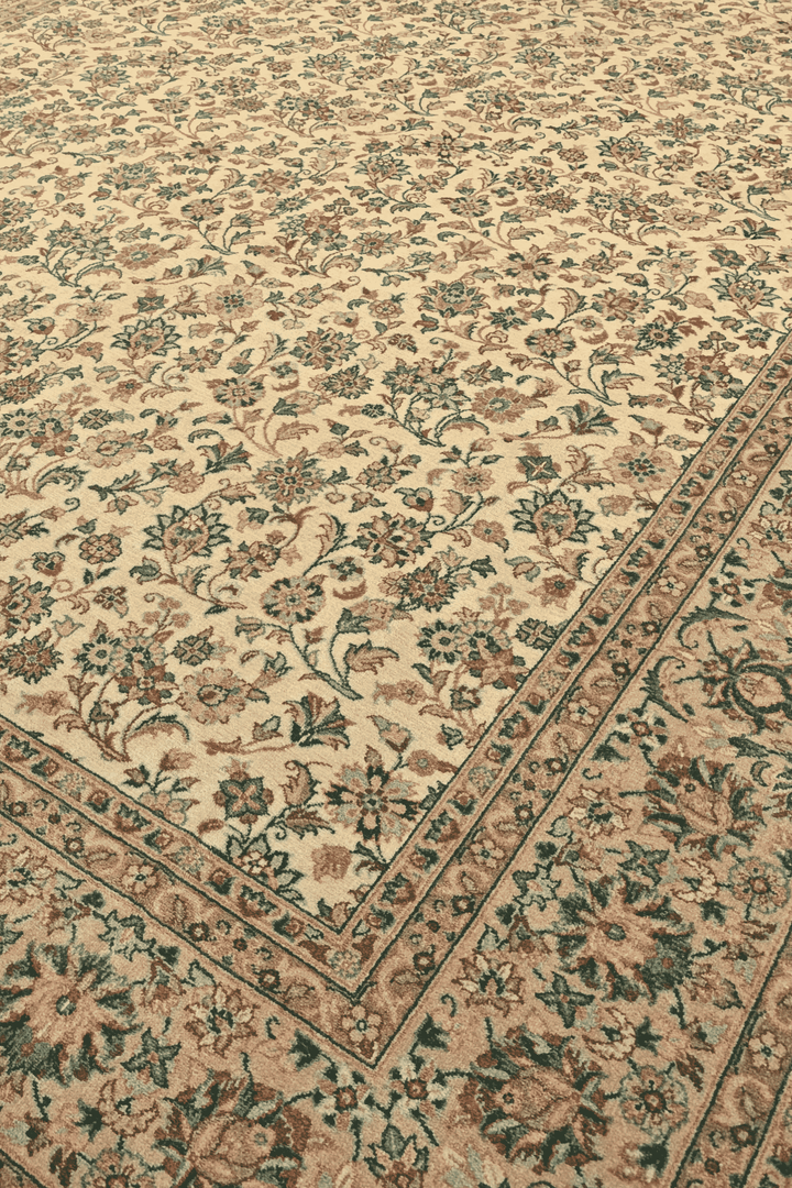Afshan floral vine detail in cream and green on Pakistani rug