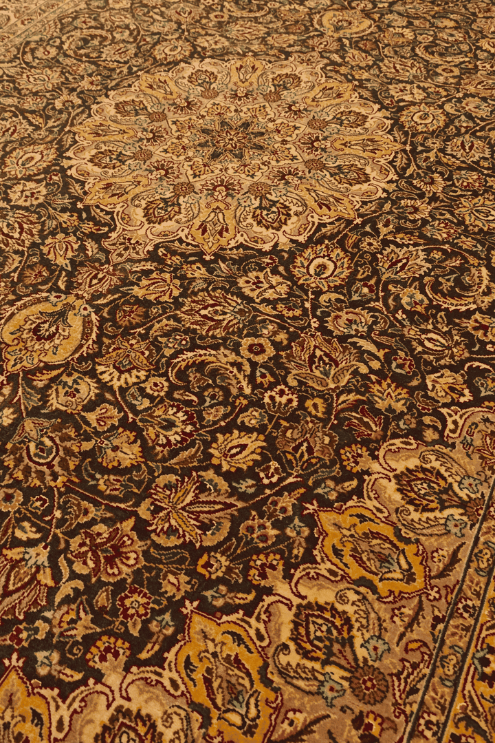 Medallion detail in espresso brown and gold on Tabriz rug