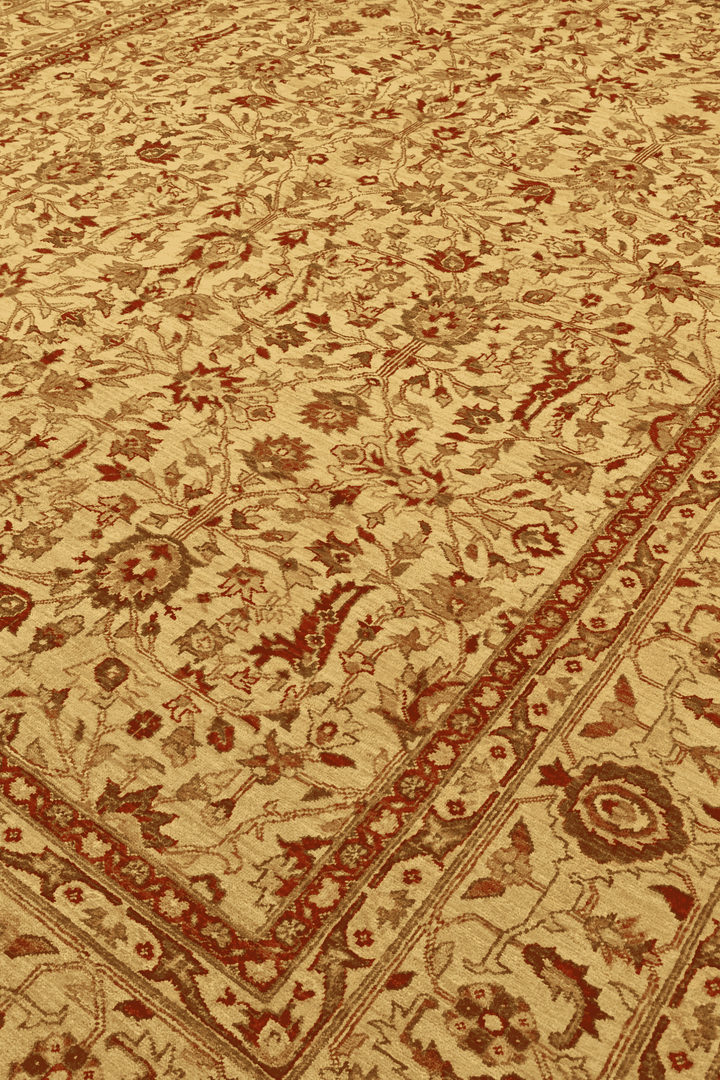 Floral vine detail in gold and red on Pakistani rug