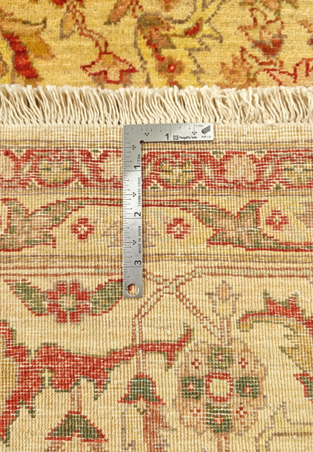 Corner of gold red vine Pakistani double-knot rug