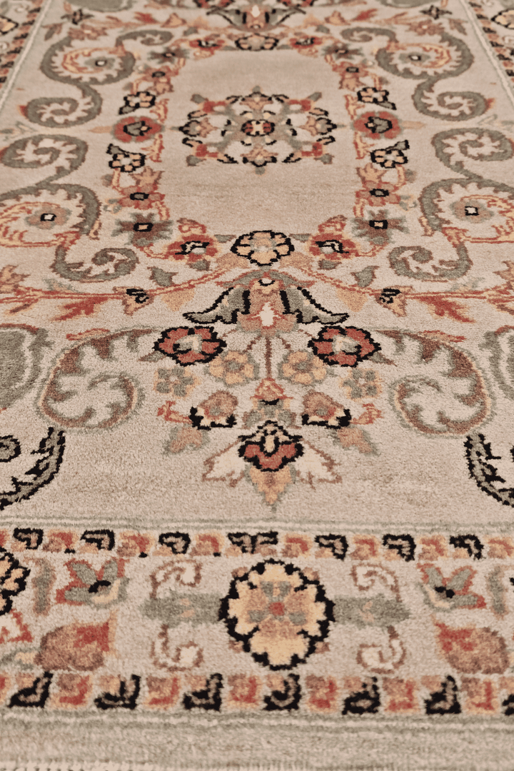 Hand-knotted blush rug with sage scrolling leaf medallion