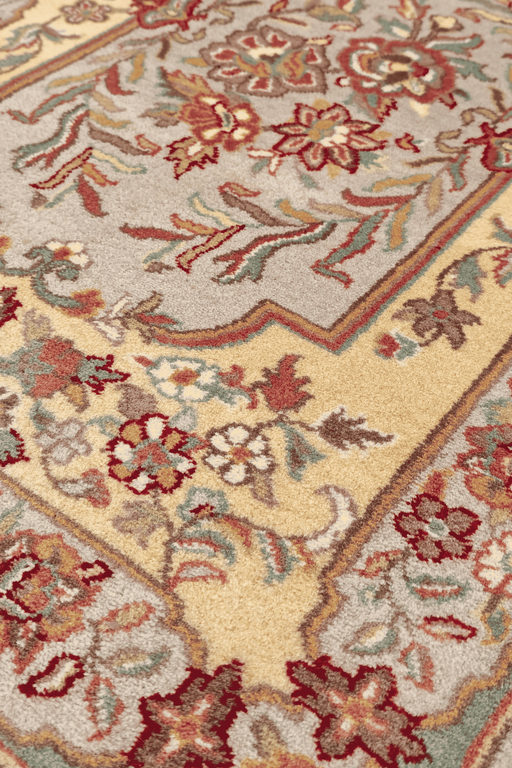 Aubusson style floral panel in gold and grey on hand-knotted rug