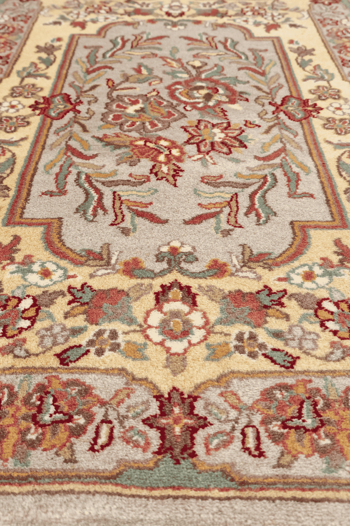 Corner of gold and grey French floral hand-knotted rug