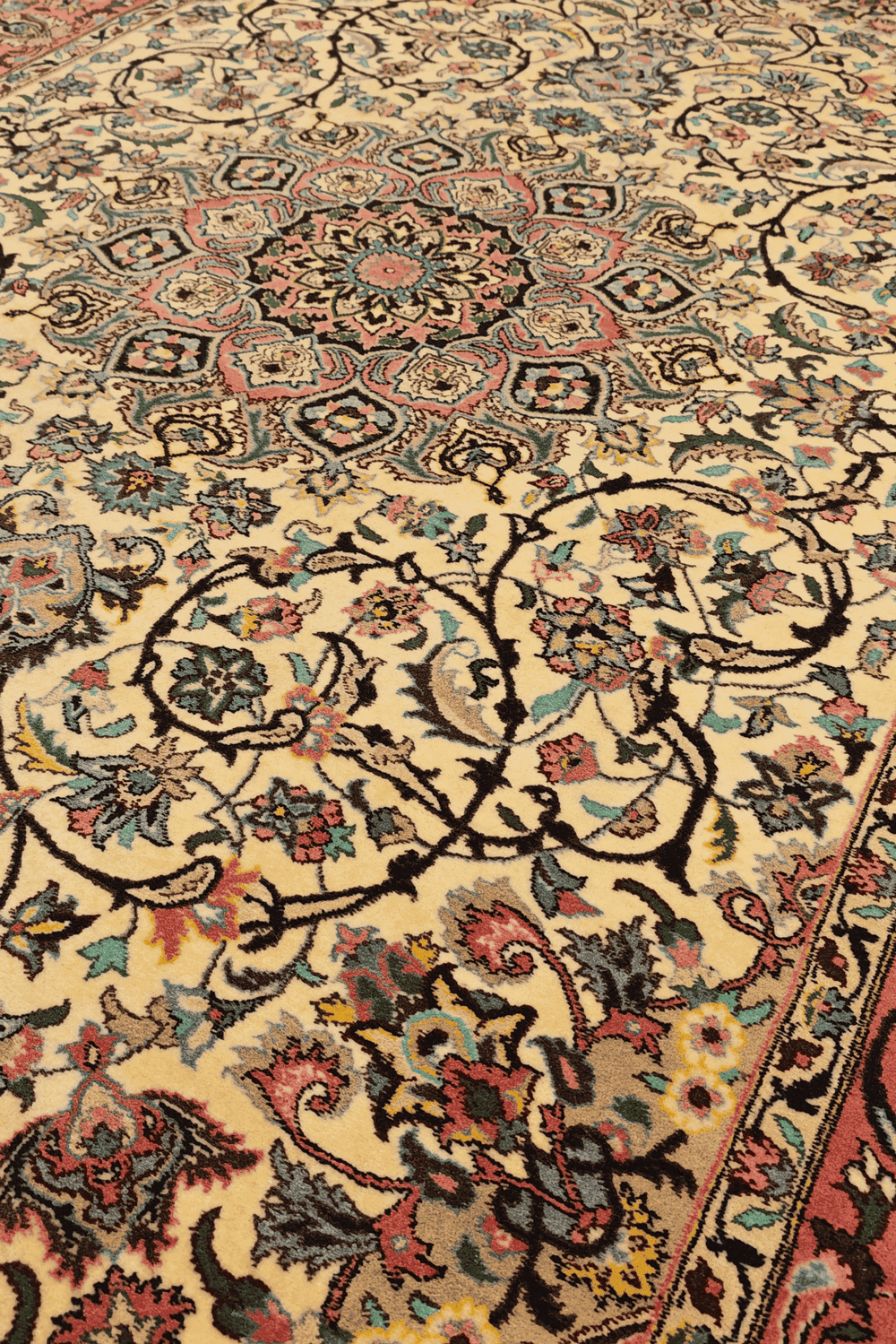 Medallion detail in rose and ivory on Tabriz rug