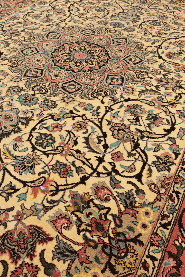 Medallion detail in rose and ivory on Tabriz rug