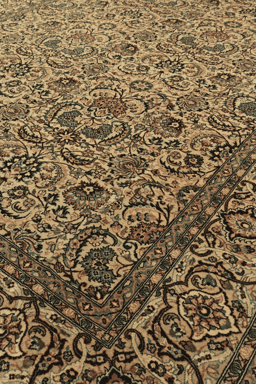 Floral vine detail in gold and teal on Pakistani rug