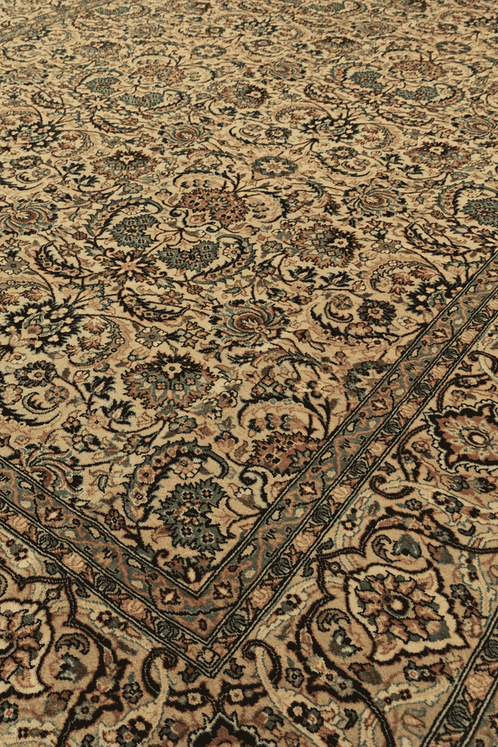 Floral vine detail in gold and teal on Pakistani rug