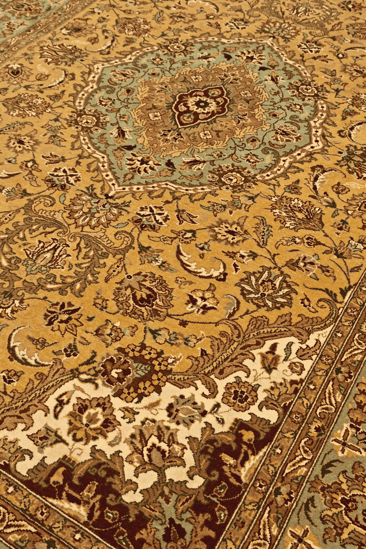 Medallion detail in mustard and sage on Tabriz rug