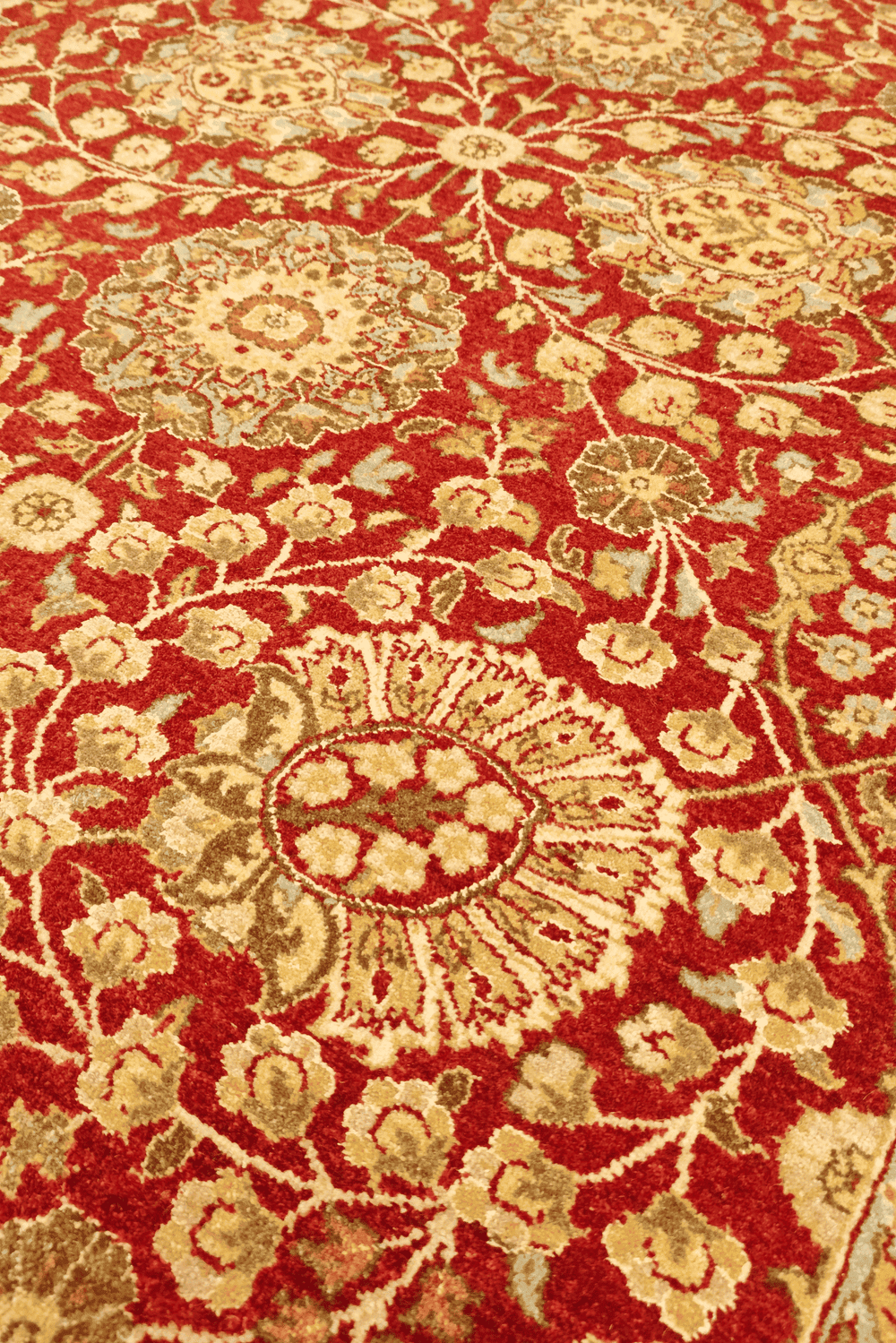 Tabriz floral detail in pomegranate red and gold on Pakistani rug