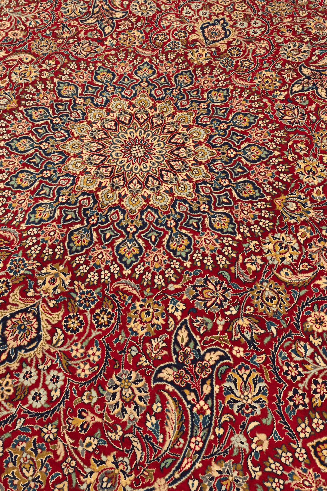 Medallion detail in garnet and navy on Tabriz rug