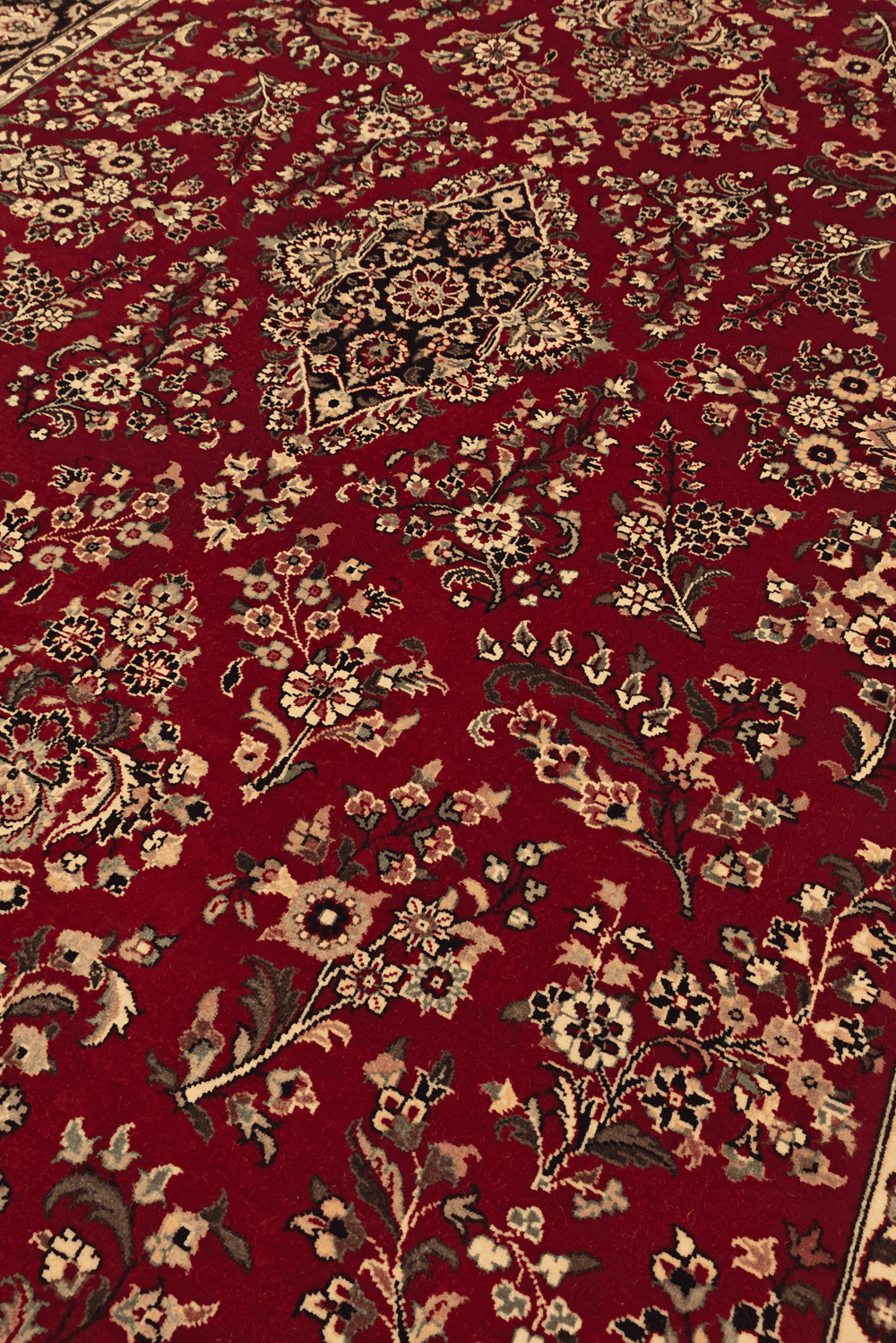 Tabriz floral detail in wine and navy on Pakistani rug