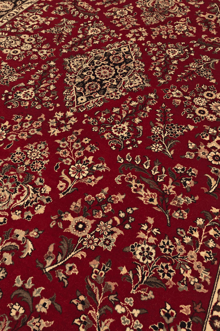 Tabriz floral detail in wine and navy on Pakistani rug
