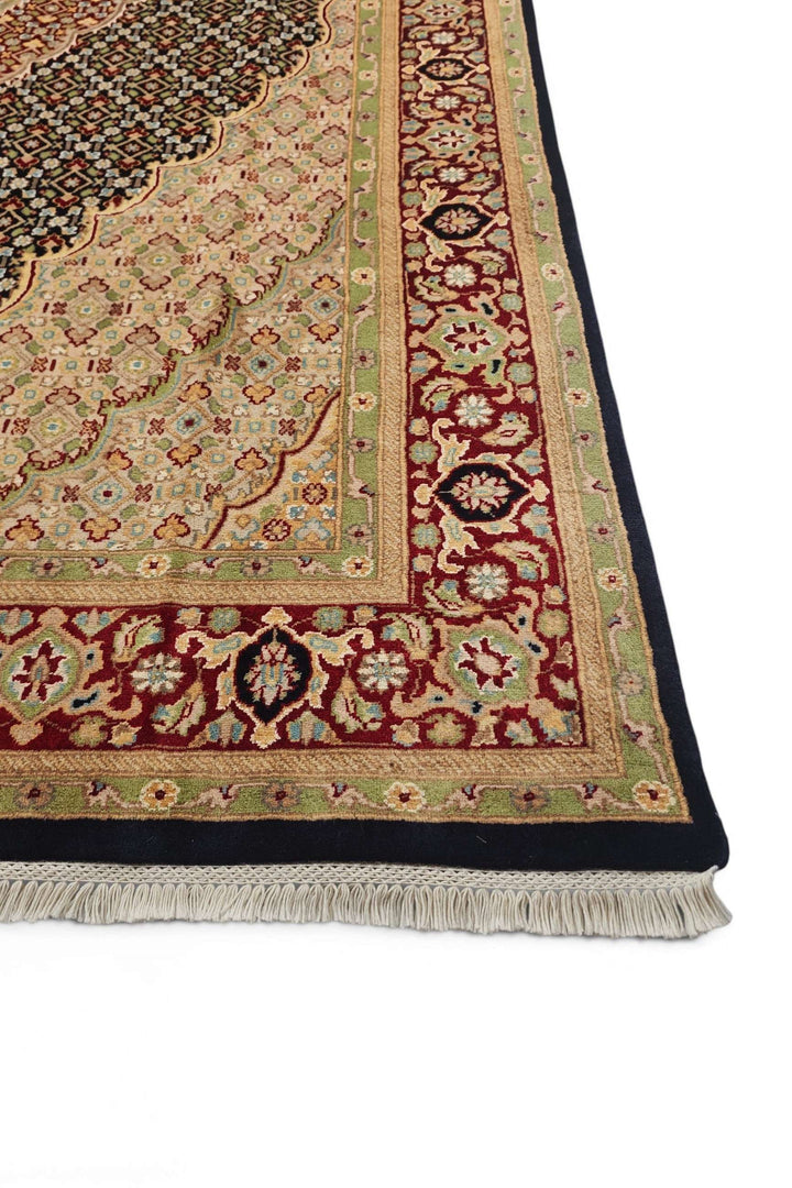 Fringe of navy and cream Tabriz mahi wool and silk rug