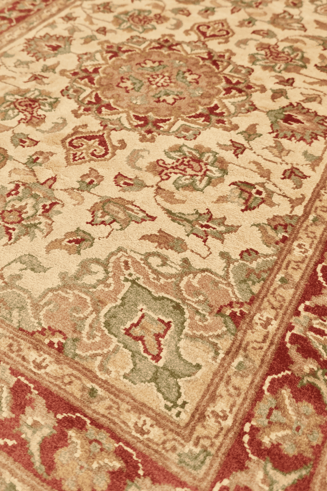 Medallion detail in cream and brick red on Tabriz wool and silk rug