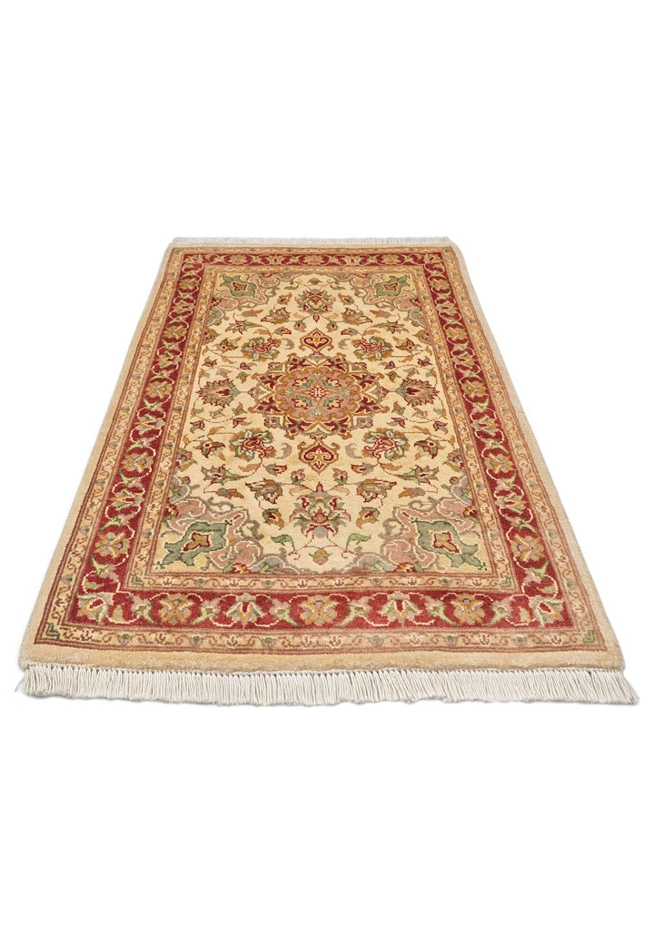 Border detail of cream brick red Tabriz hand-knotted rug