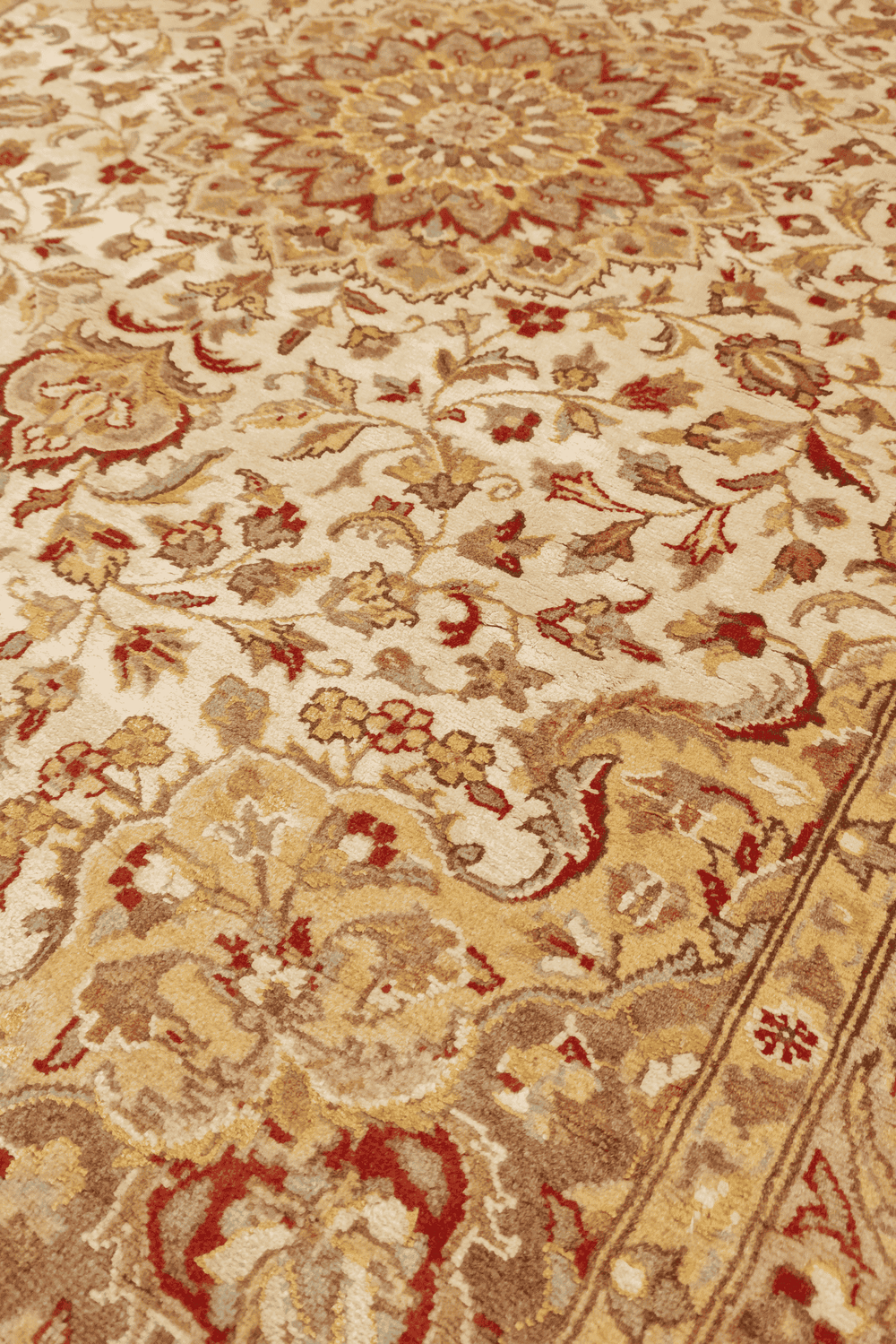 Medallion detail in ivory on pure silk Tabriz rug