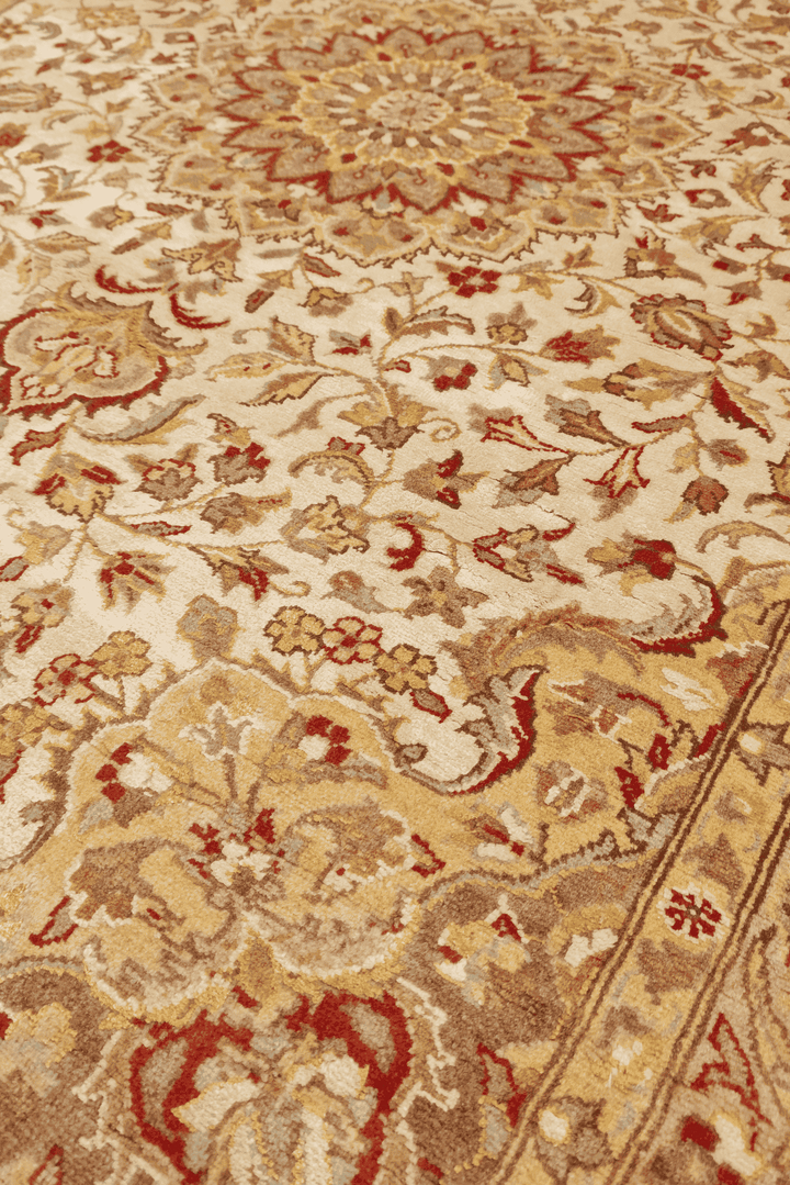 Medallion detail in ivory on pure silk Tabriz rug