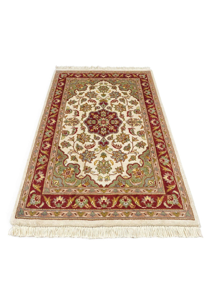 Border detail of ivory deep red Tabriz hand-knotted rug