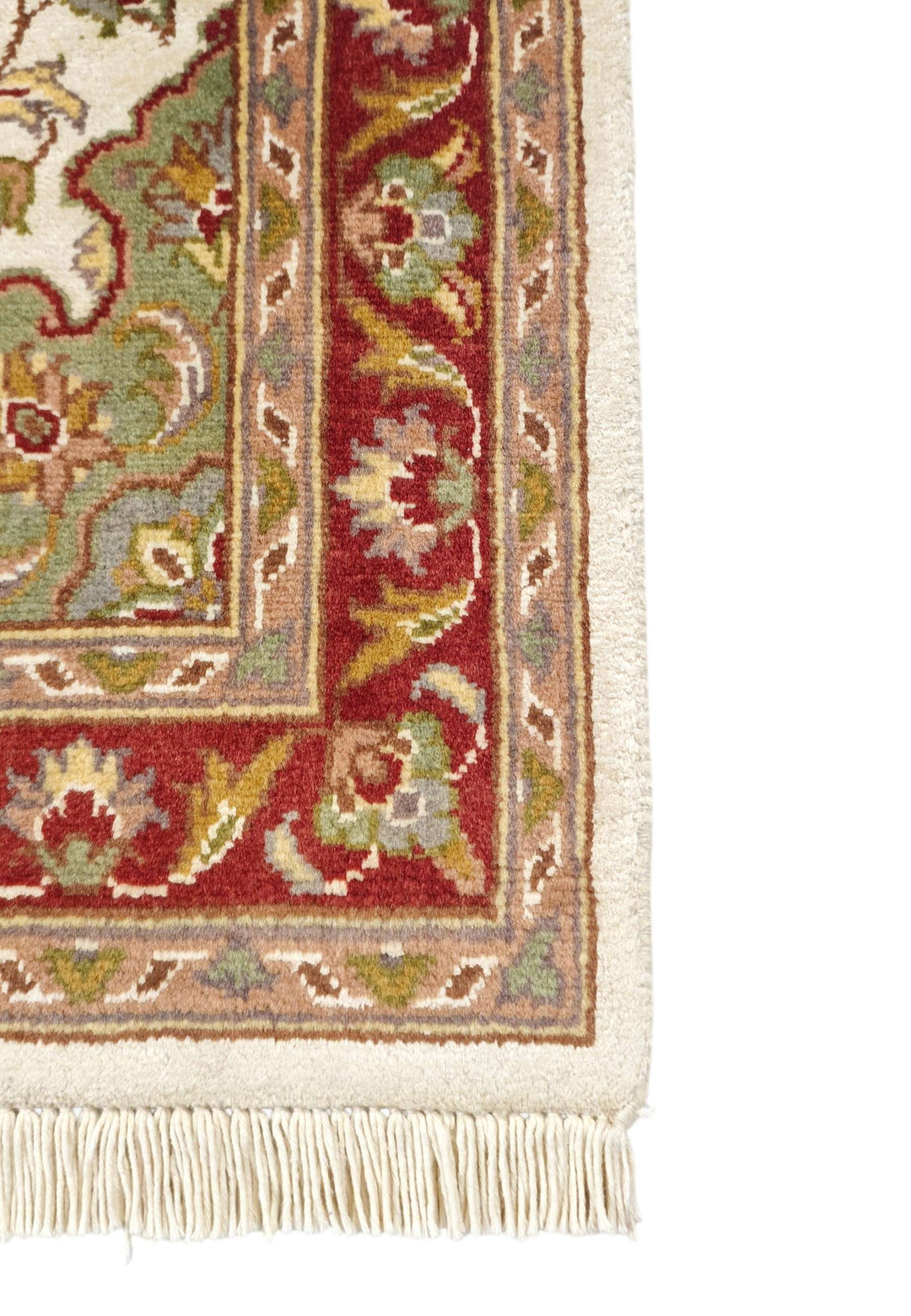 Corner of ivory and deep red Tabriz hand-knotted rug