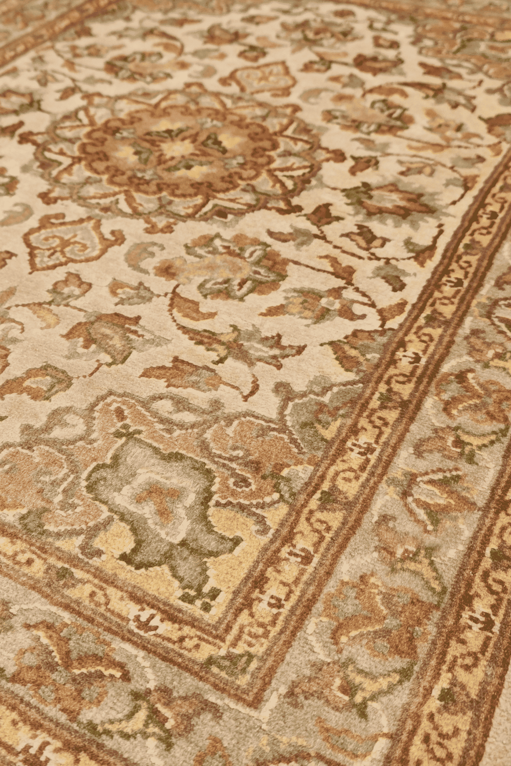 Medallion detail in ivory and coral on Tabriz wool and silk rug