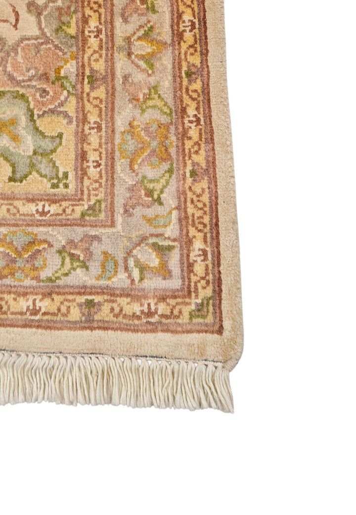 Hand-knotted ivory Tabriz rug with silk coral medallion