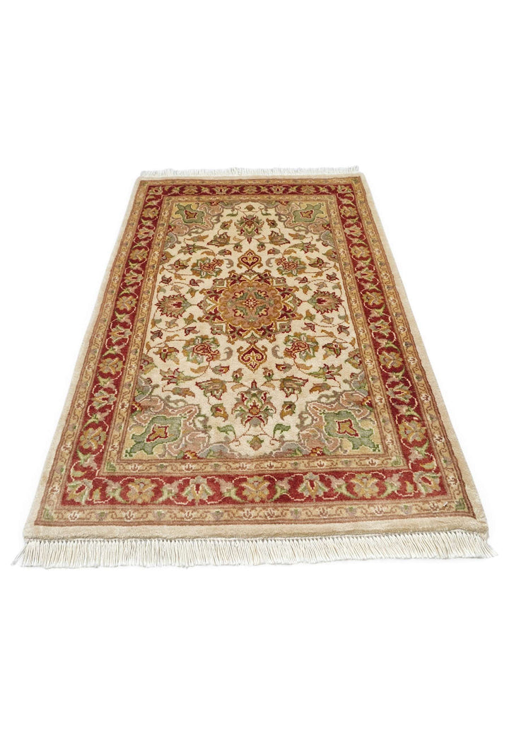 Border detail of ivory Tabriz hand-knotted wool and silk rug