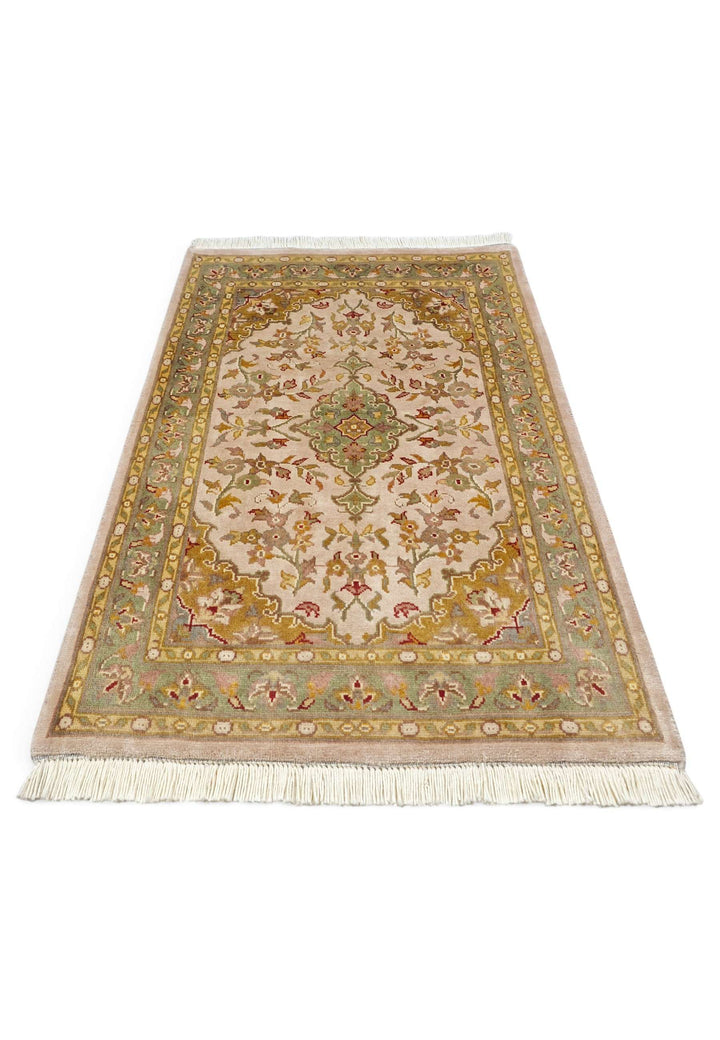 Border detail of blush ochre Tabriz hand-knotted rug