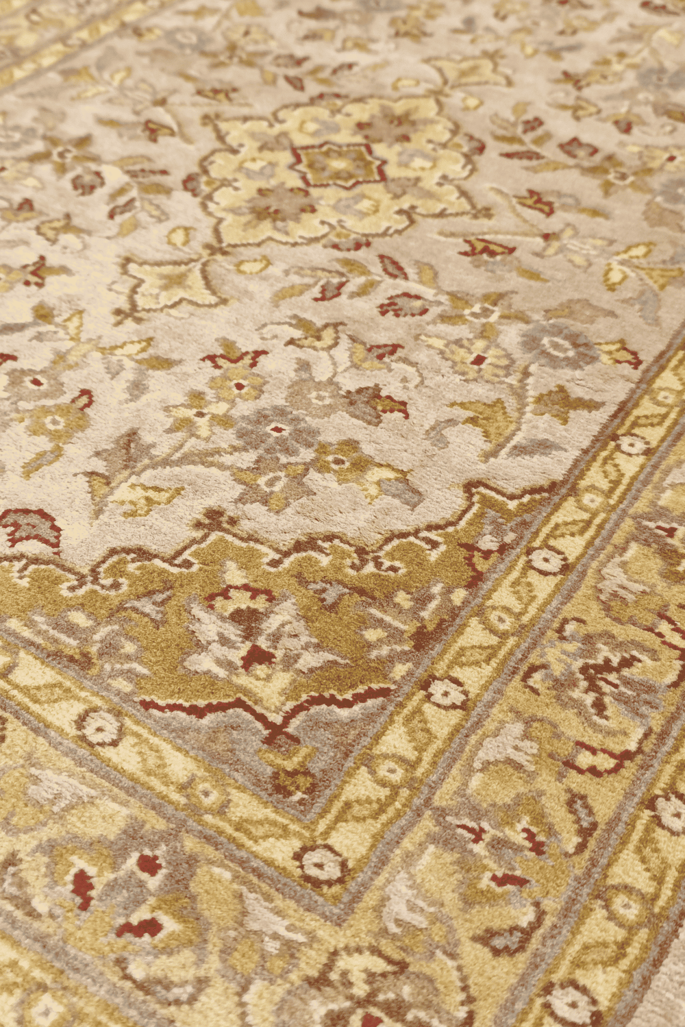 Medallion detail in blush and olive gold on Tabriz rug