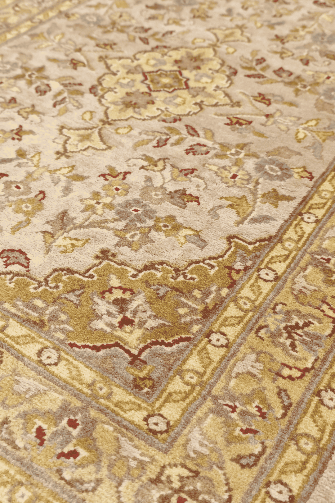 Medallion detail in blush and olive gold on Tabriz rug