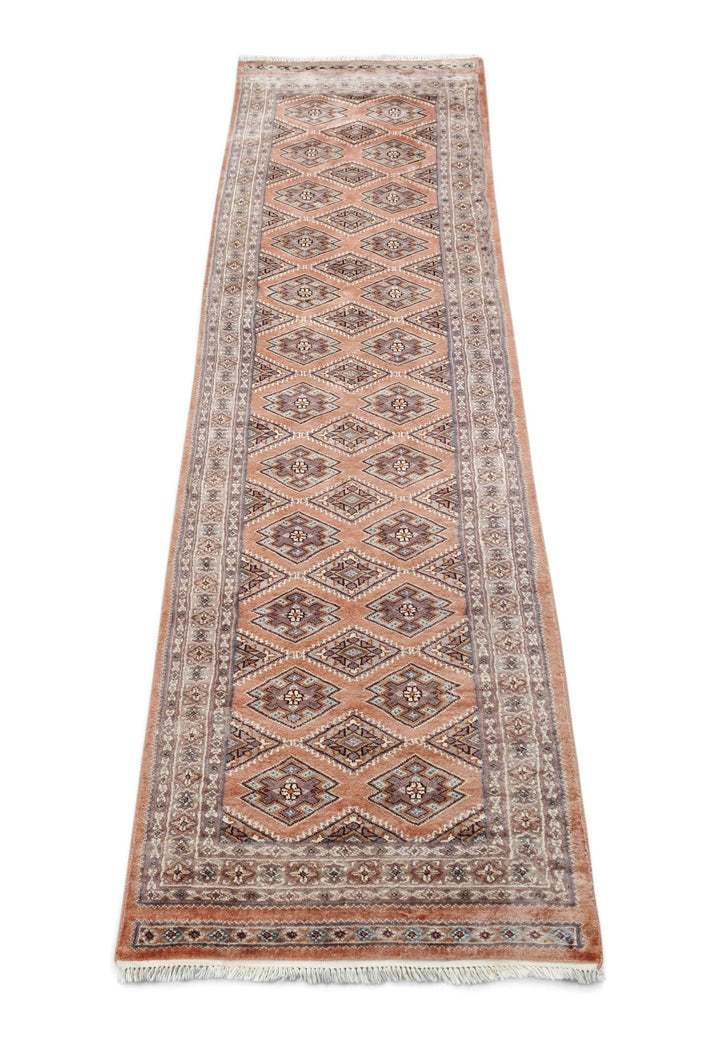 Border detail of salmon Jaldar hand-knotted Pakistani runner