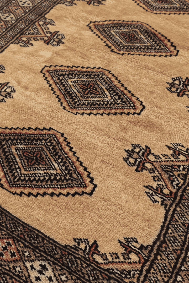 Diamond medallion detail in camel and dusty rose on Jaldar runner