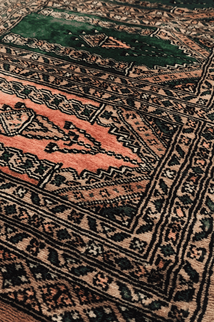Saf arched niche detail in camel and salmon on Pakistani rug