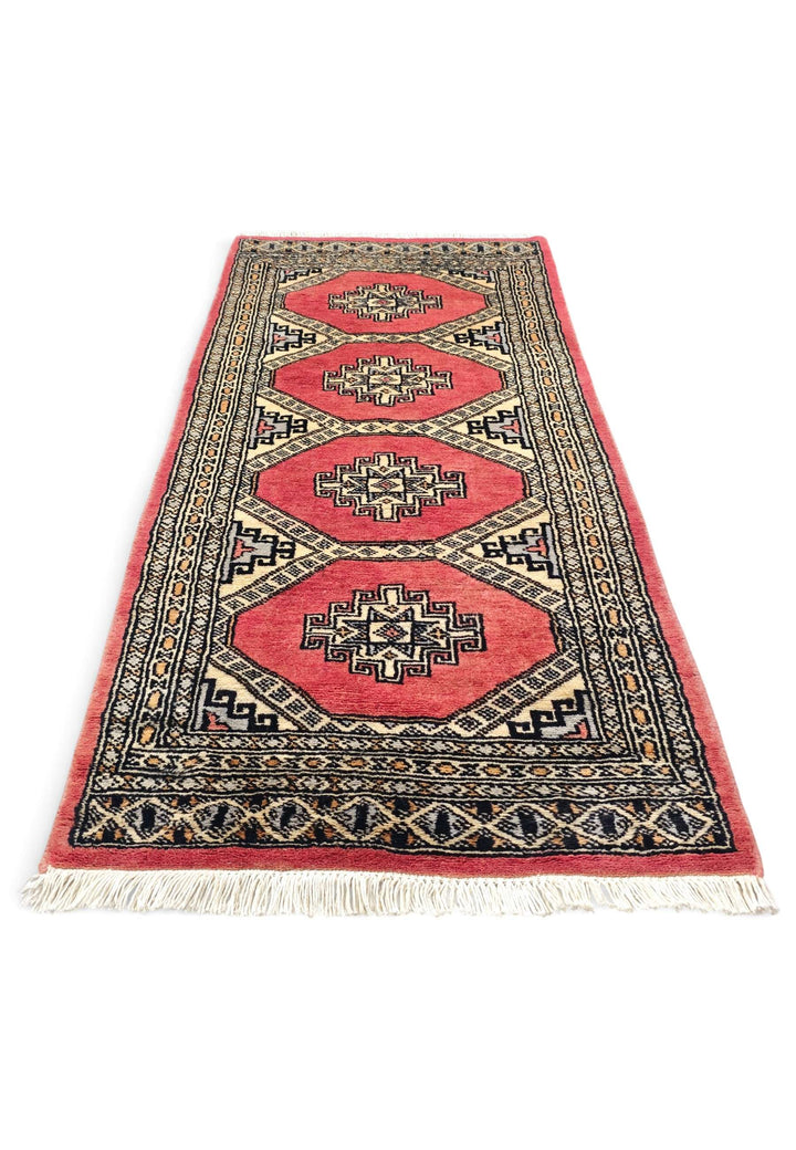 Border detail of coral Jaldar hand-knotted Pakistani rug