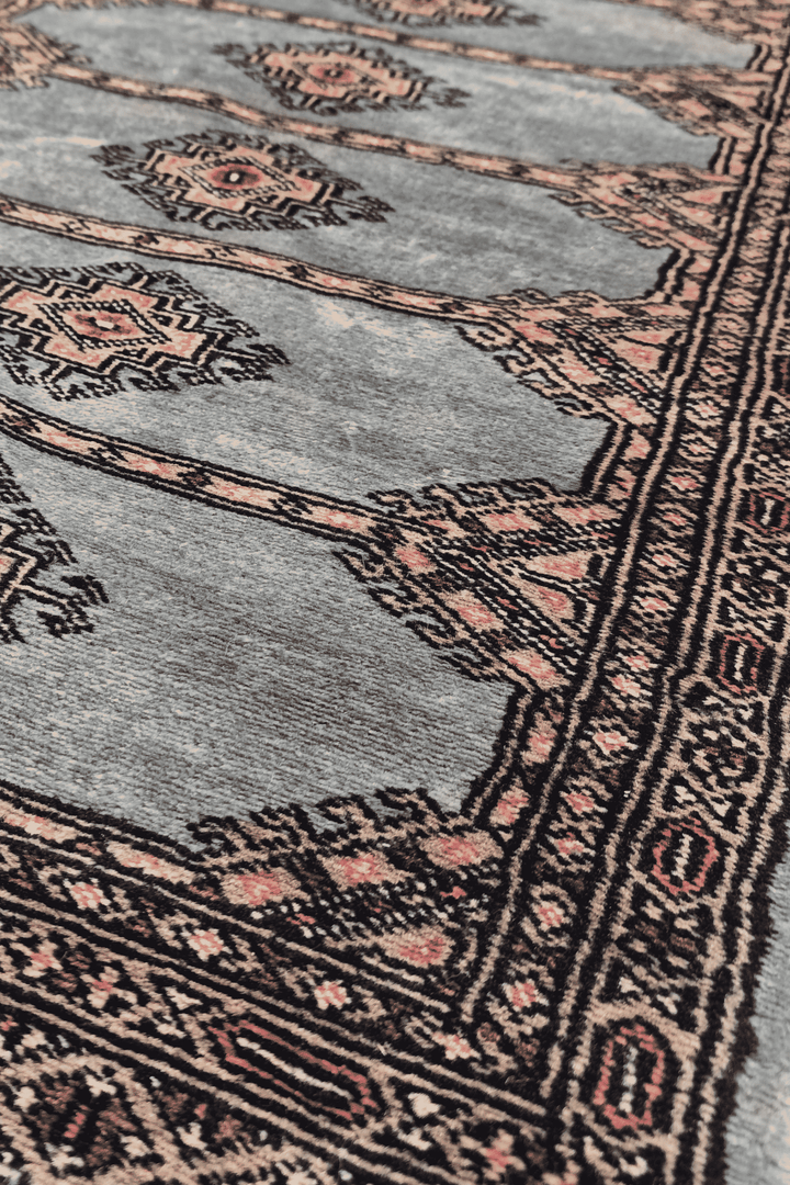 Diamond medallion detail in dusty blue and peach on Jaldar rug