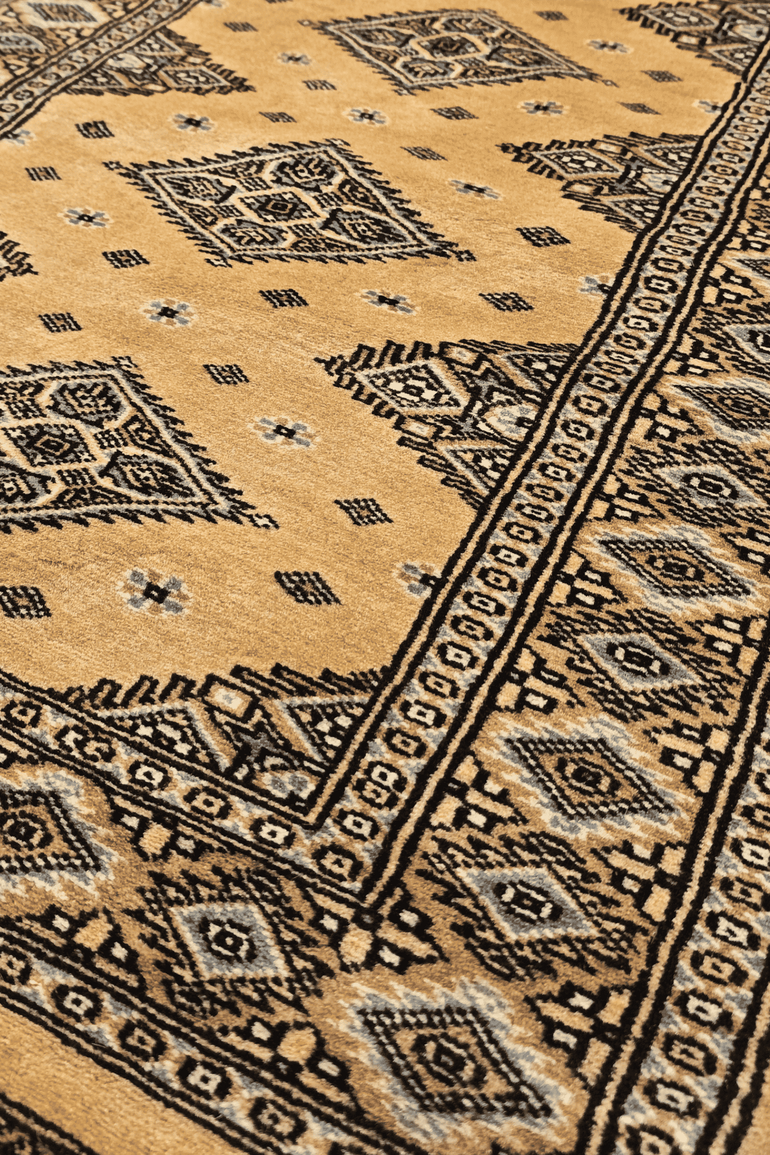 Diamond medallion detail in honey gold and espresso on Jaldar rug