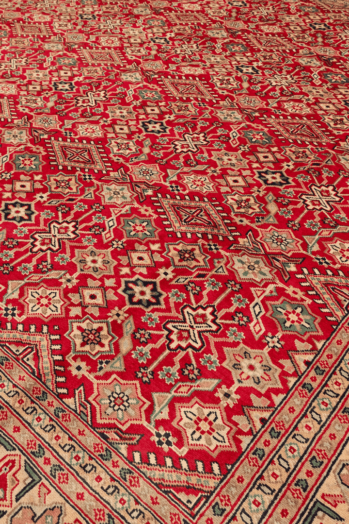 Border detail of red Jaldar hand-knotted square Pakistani rug