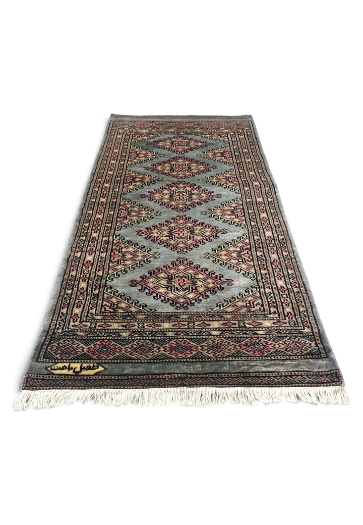 Border detail of grey-green Jaldar hand-knotted Pakistani rug