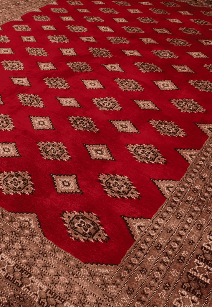 Diamond detail in brick red and cream on Jaldar rug