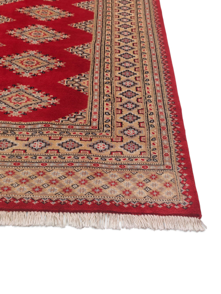 Corner of crimson and camel Jaldar hand-knotted rug