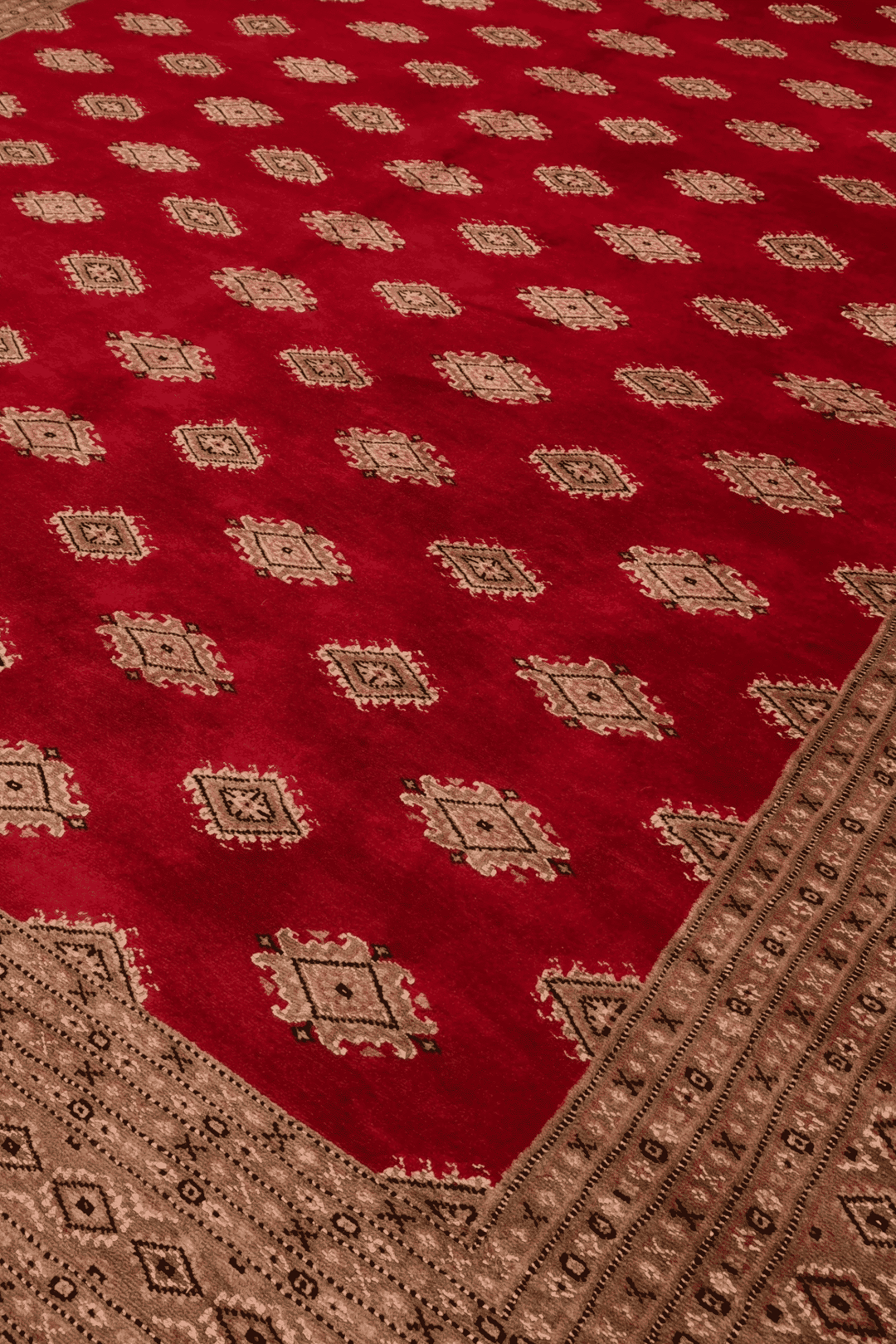 Diamond detail in ruby red and cream on Jaldar rug