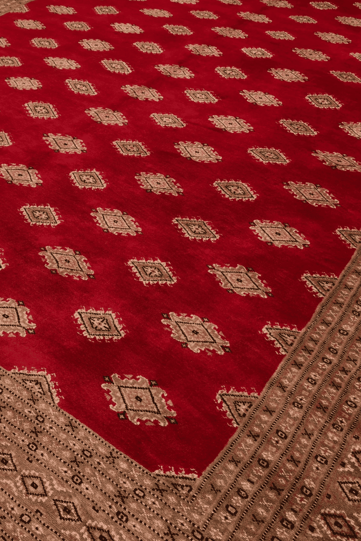 Diamond detail in ruby red and cream on Jaldar rug
