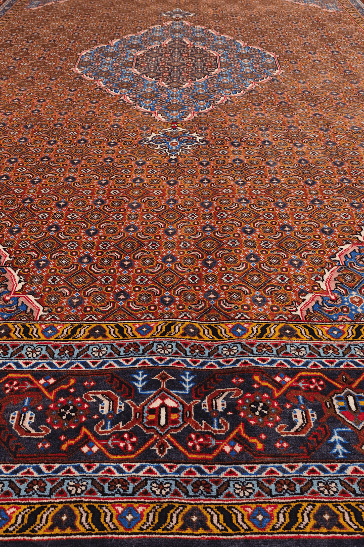 Fringe of terracotta Persian Ardabil rug