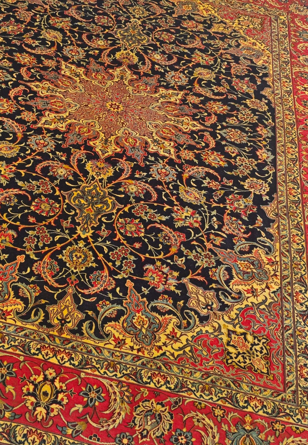Arabesque medallion detail in black and red on Sirafian Isfahan rug