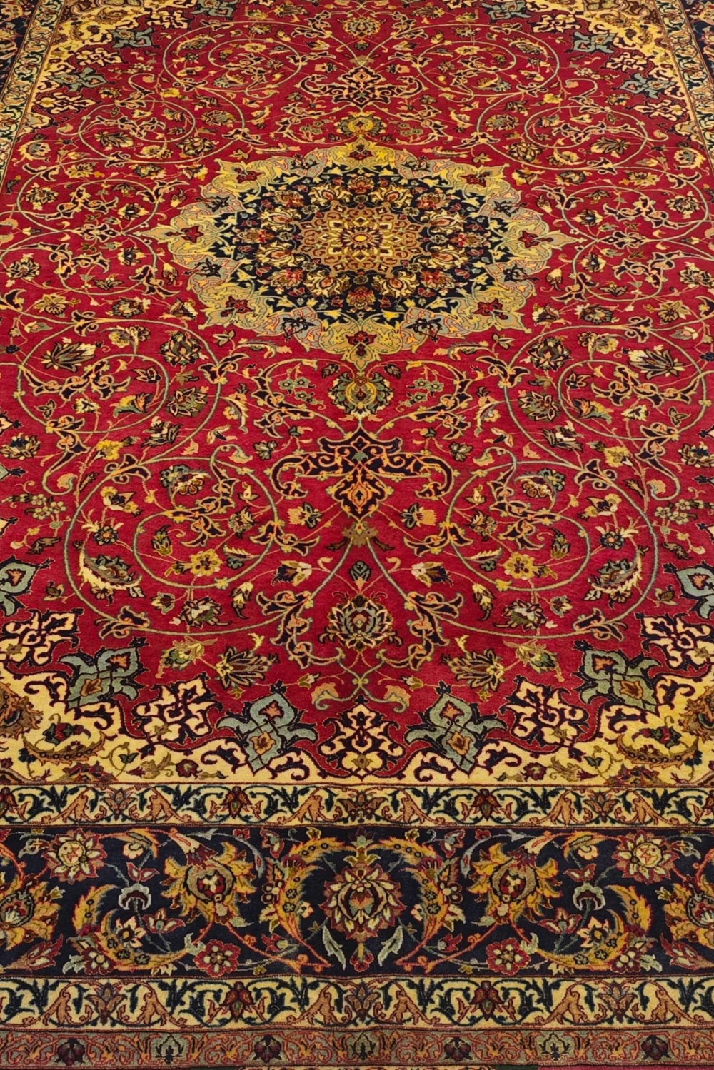 Arabesque medallion detail in crimson and gold on Sirafian Isfahan rug