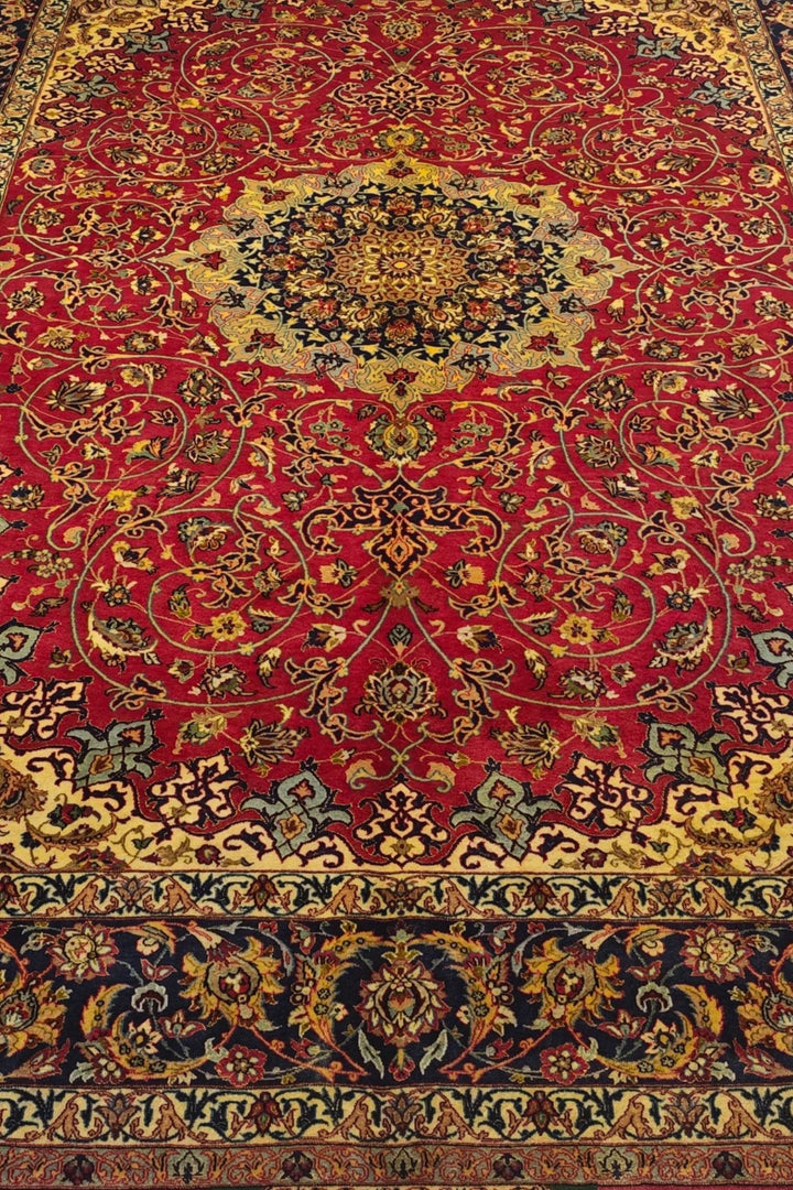 Arabesque medallion detail in crimson and gold on Sirafian Isfahan rug